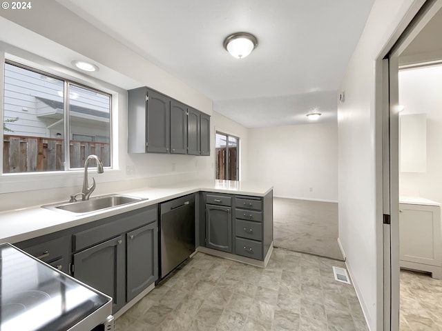 kitchen featuring kitchen peninsula, light carpet, sink, gray cabinets, and stainless steel dishwasher