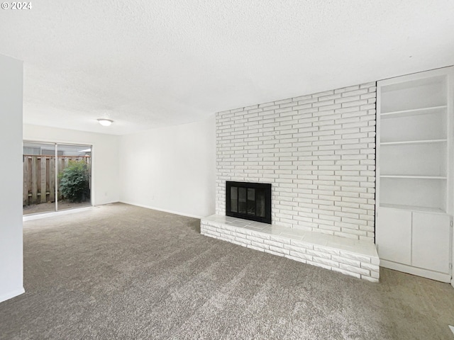 unfurnished living room featuring carpet flooring, a fireplace, and a textured ceiling