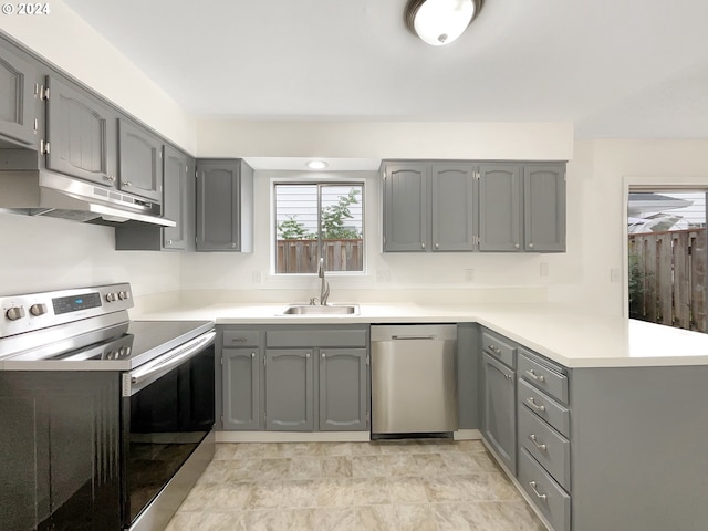 kitchen featuring gray cabinets, appliances with stainless steel finishes, and sink