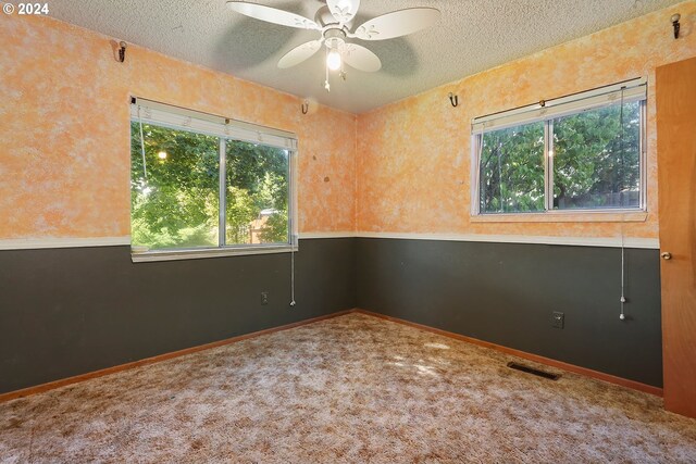 kitchen featuring sink, a textured ceiling, kitchen peninsula, ceiling fan, and light hardwood / wood-style floors