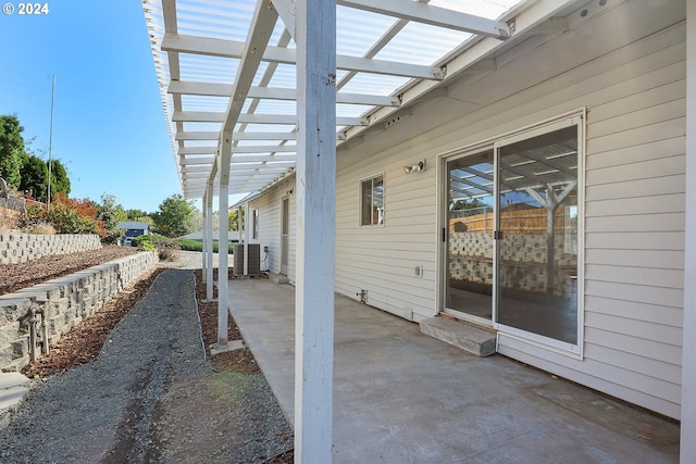 view of patio with central AC and a pergola