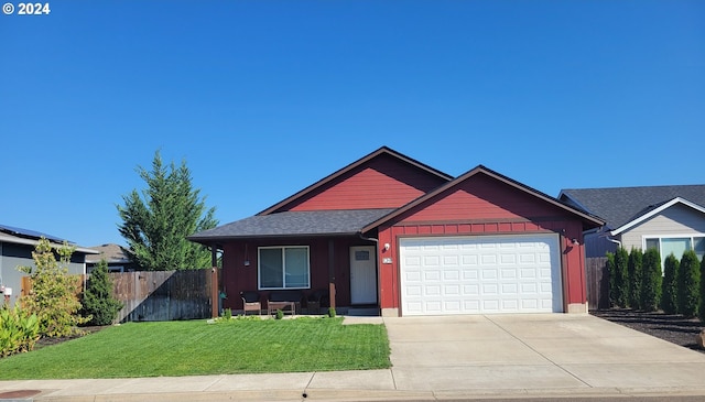 view of front of home featuring a front yard and a garage