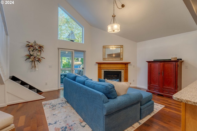 living room with dark hardwood / wood-style floors and high vaulted ceiling