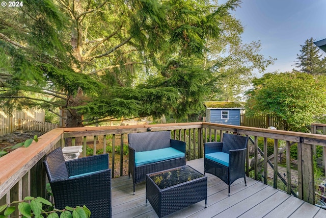 wooden terrace with a storage shed and an outdoor hangout area