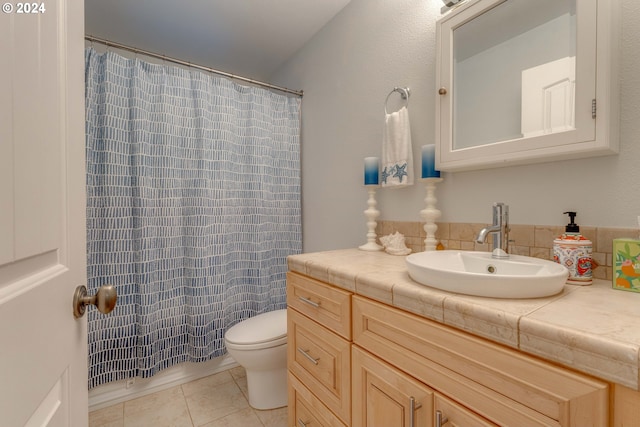 bathroom featuring a shower with shower curtain, tile patterned flooring, vanity, and toilet