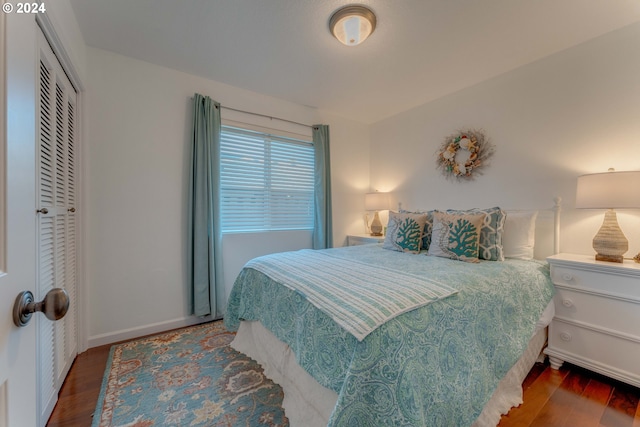 bedroom with a closet and dark hardwood / wood-style floors