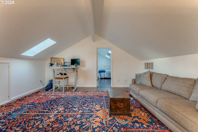 living room featuring a textured ceiling and lofted ceiling with skylight