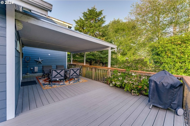 wooden deck featuring a grill