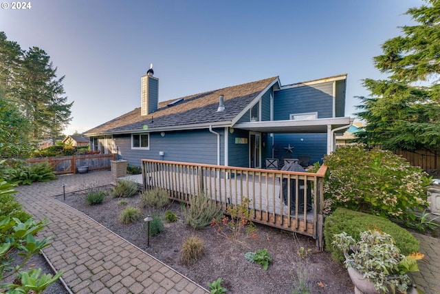 rear view of property with a wooden deck