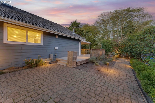 patio terrace at dusk featuring a deck