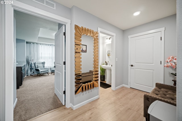 entryway with sink and light carpet