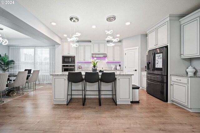 kitchen featuring pendant lighting, a center island, a chandelier, and stainless steel appliances