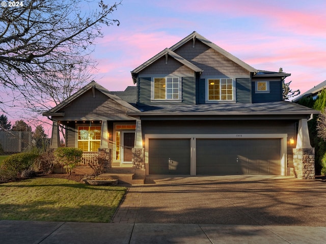 craftsman-style home with a yard and a garage