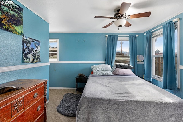 bedroom featuring carpet floors, ceiling fan, and crown molding