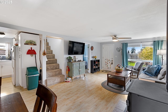 living room featuring ceiling fan and light wood-type flooring