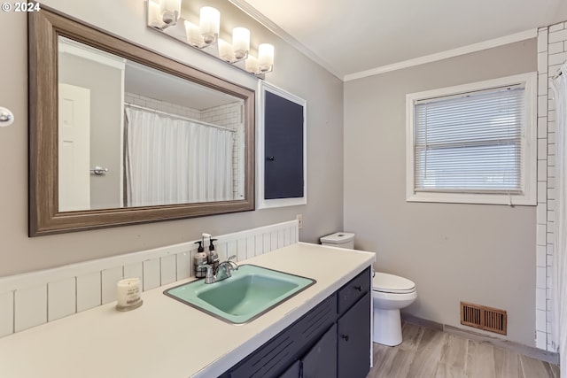 bathroom with walk in shower, toilet, ornamental molding, vanity, and hardwood / wood-style floors