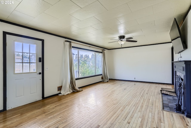 unfurnished living room featuring light hardwood / wood-style flooring, ceiling fan, and plenty of natural light