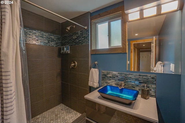 bathroom with curtained shower, sink, and backsplash