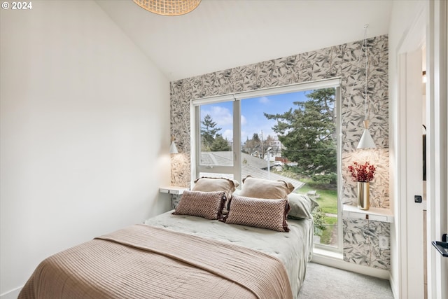 bedroom featuring multiple windows, light colored carpet, and vaulted ceiling