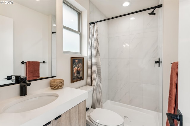 bathroom with vanity, toilet, and curtained shower