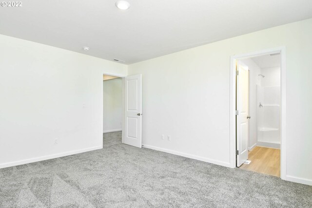 unfurnished room with light carpet