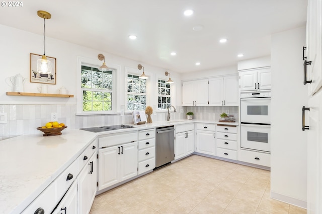 kitchen with dishwasher, white double oven, and white cabinetry