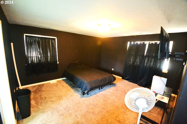 carpeted bedroom featuring a textured ceiling