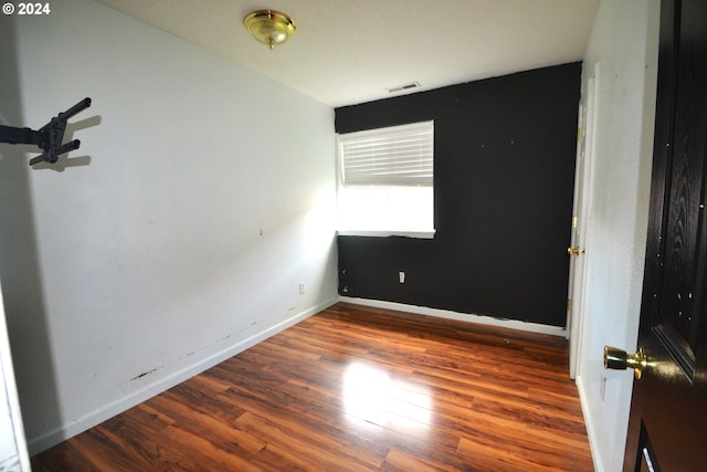 spare room featuring dark wood-type flooring