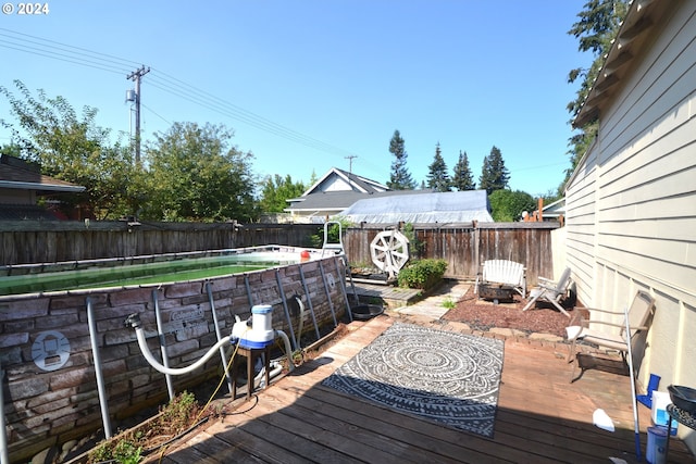 wooden terrace featuring a pool