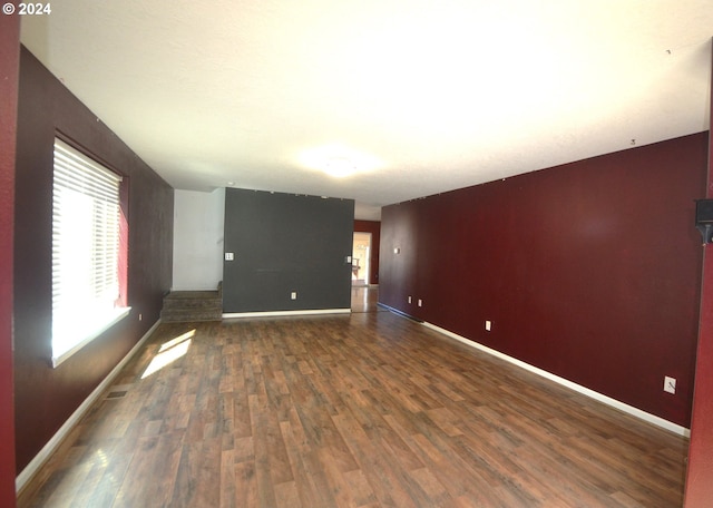 unfurnished room with dark wood-type flooring