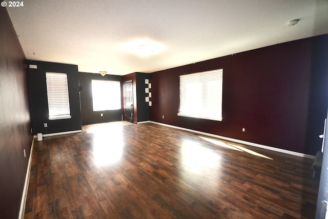 spare room with dark wood-type flooring