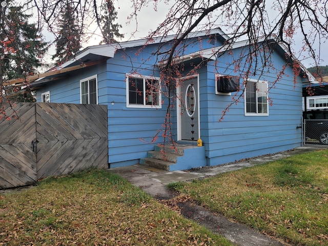 bungalow-style home with a front lawn