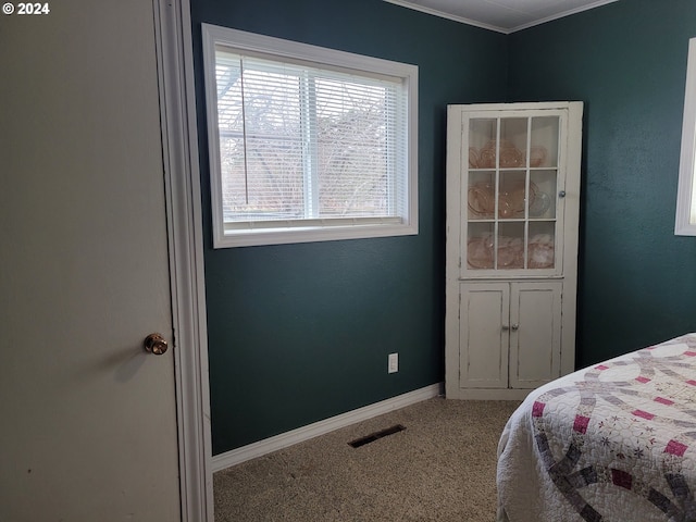 carpeted bedroom with crown molding