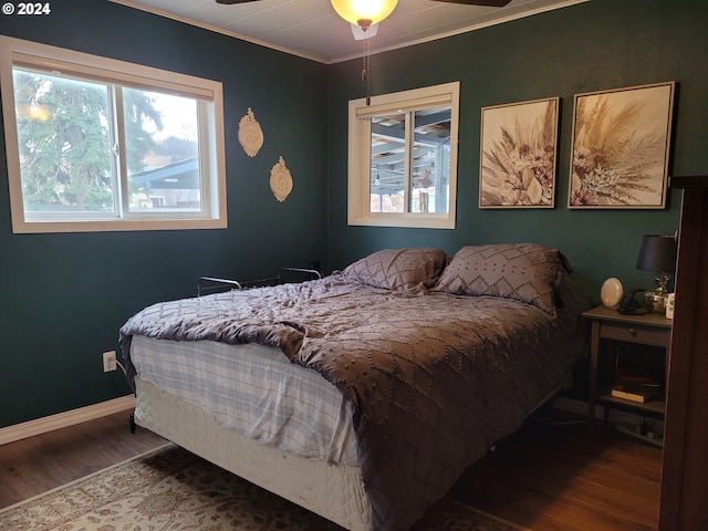 bedroom featuring ceiling fan, wood-type flooring, and crown molding