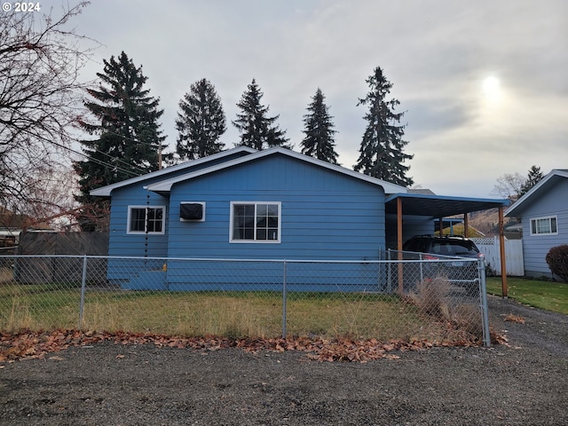 view of home's exterior featuring a yard and a carport