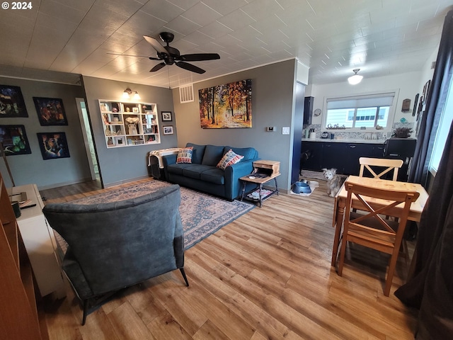 living room featuring hardwood / wood-style flooring and ceiling fan