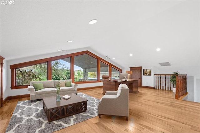 living room with lofted ceiling and light hardwood / wood-style flooring