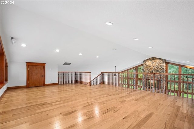 bonus room featuring lofted ceiling and light hardwood / wood-style floors