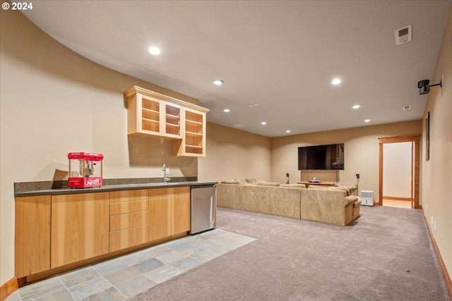 kitchen featuring light colored carpet, refrigerator, sink, and light brown cabinets