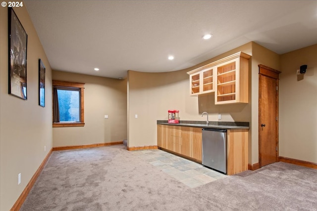 kitchen with sink, stainless steel dishwasher, light colored carpet, and light brown cabinets