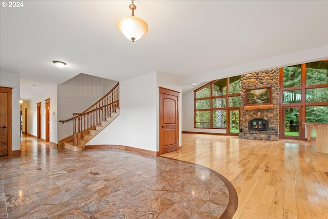 living room featuring a stone fireplace