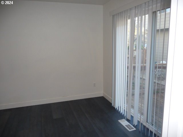 empty room featuring dark wood-type flooring