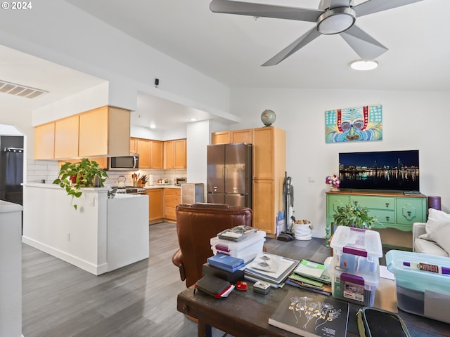 living room featuring ceiling fan, hardwood / wood-style floors, and lofted ceiling