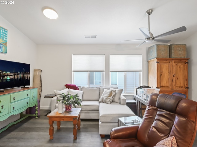 living room with ceiling fan and dark hardwood / wood-style flooring