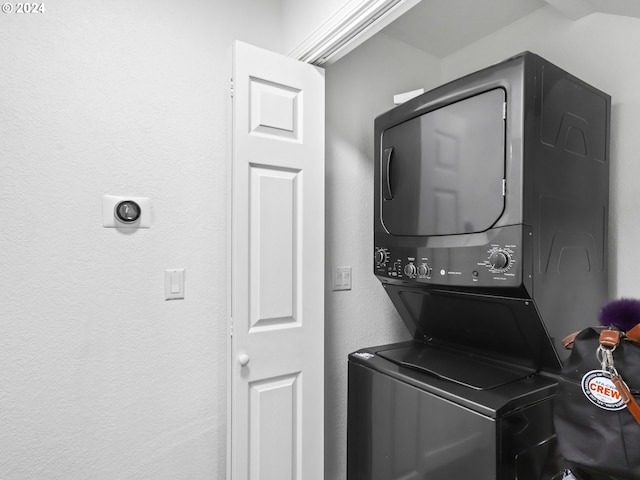 clothes washing area featuring stacked washer and dryer