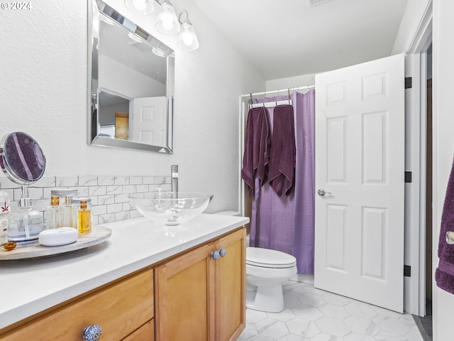 bathroom featuring vanity, tile patterned floors, toilet, tasteful backsplash, and curtained shower