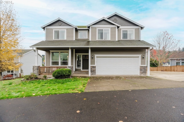 craftsman-style house with a porch, a garage, and a front lawn