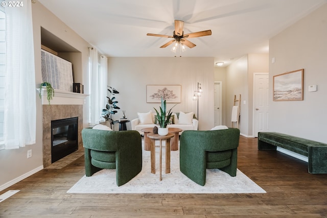 living room featuring a fireplace, ceiling fan, and hardwood / wood-style floors