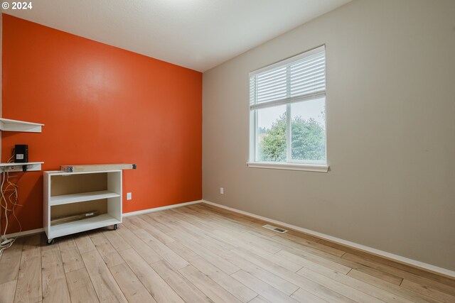 empty room with light hardwood / wood-style floors