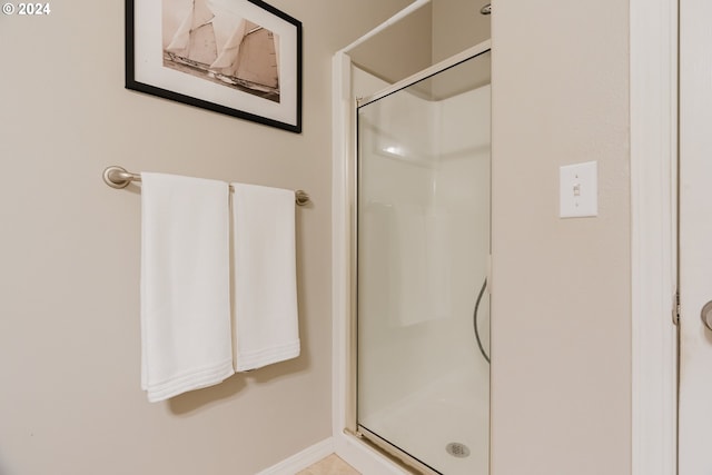 bathroom with a shower with shower door